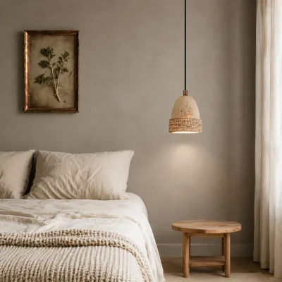 Wabi-sabi woven stone pendant light installed beside a bed